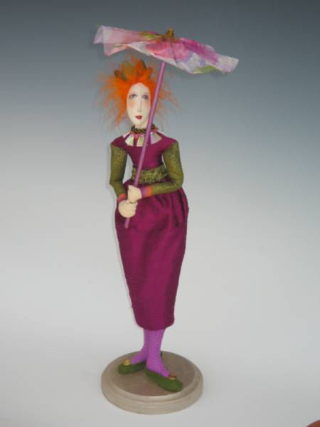 This graceful 18" figure carries a beautiful parasol to keep the color in her hair and off her skin.