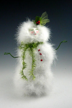 With a little bit of paper mache, paper clay, painting, wire bending and pin pushing you can create this truly marvelous 12” snow gal.
