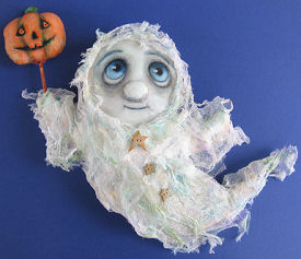 Pattern to Sew a 13" ghost dressed in stiffened cheesecloth is holding a painted pumpkin wand.