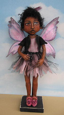 16” painted fairy with beautiful tyvek wings and a fringed tulle and fabric skirt.