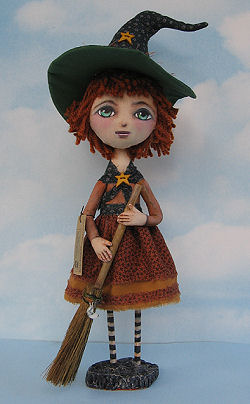 A clay base and wooden dowels support the body of this sweet 16” witch.