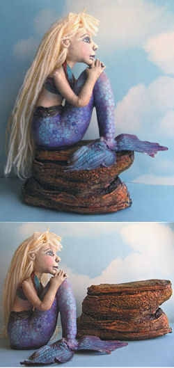 This pensive 6" x 8" painted muslin mermaid is made to sit on or off her rock which is made from plaster wrap and then painted.