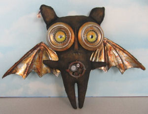 You'll be cutting up some aluminum drink cans to form the eyes and wings of this 11" x 13" Steampunk Bat.