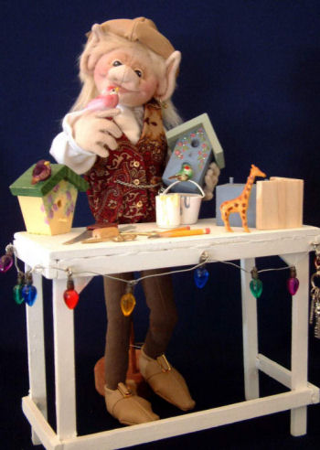 Shae - 12" elf holds a birhouse and stand with the aid of a simple platform.
