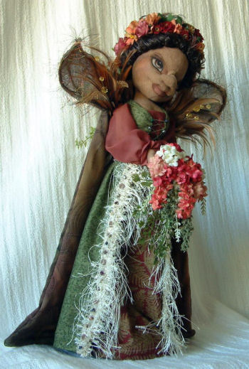 Silk flowers, vines , feathers and more adorn this graceful 17" doll built over a wooden candle stick or a dowel and disk. Doll Making Sewing Pattern