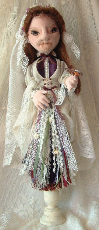 Built over a candle stick this 20” bride doll has an ethnic flair.